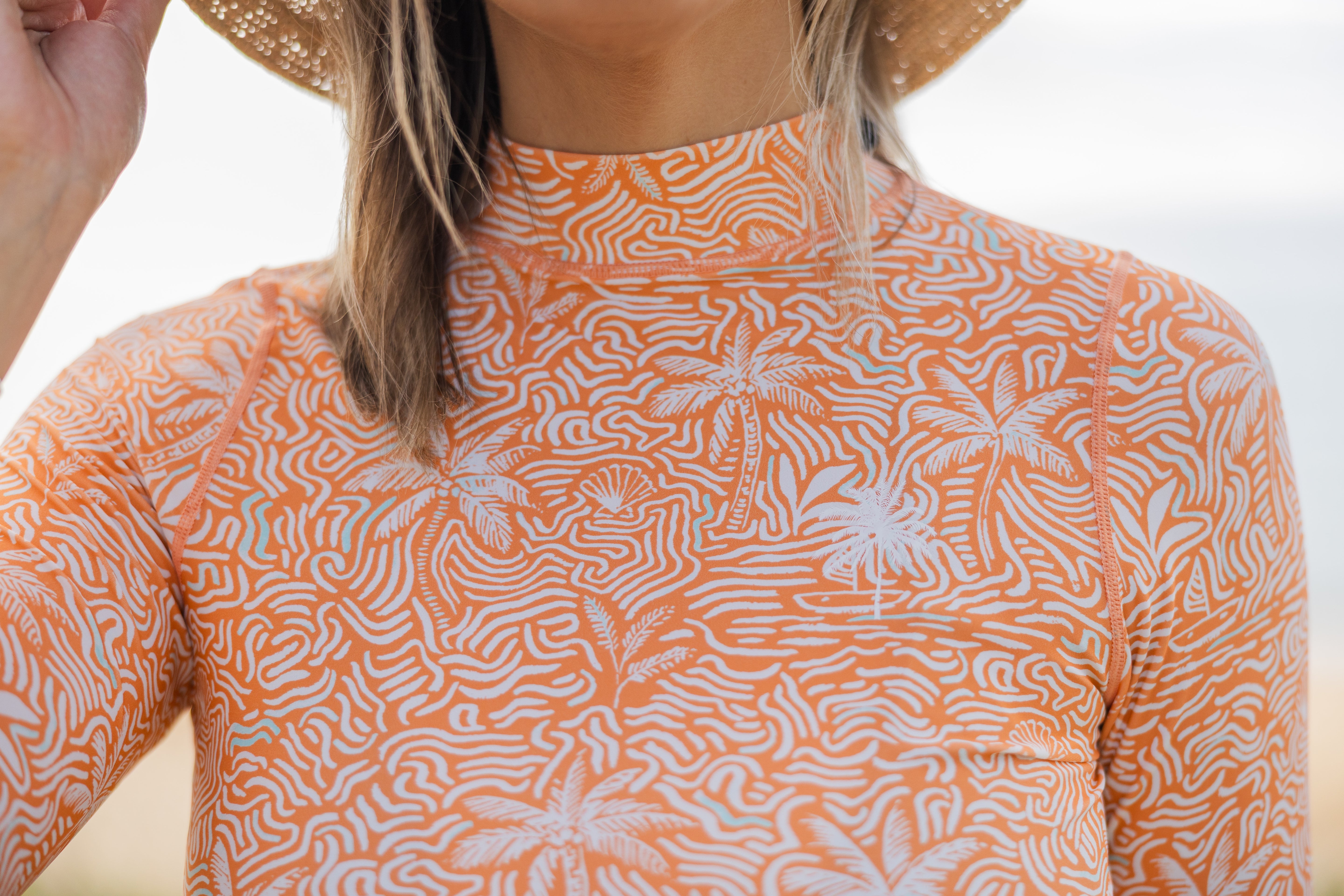 Close-up of Women Tropical Drift classic rashie with palm tree pattern by Bussin Style Co